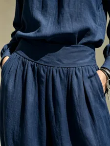 Detail shot of women casual dark blue linen outfit set featuring loose top and wide leg pants.