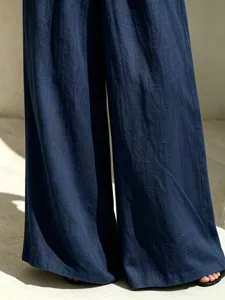 Detail shot of elegant casual navy blue cotton linen wide leg trousers for women.