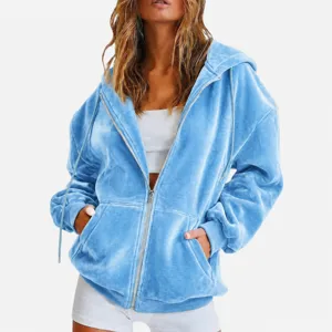 Close-up detail of blue velvet zip-up hoodie texture, soft fabric and smooth zipper.