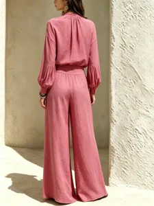 Details of casual linen outfit set featuring loose long-sleeve top and wide-leg trousers.