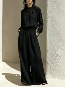 Detailed showcase of the elegant black cotton linen long sleeve top and wide leg pants.
