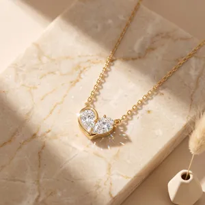 Close-up detail of an elegant heart-shaped moissanite pendant on a fine gold necklace chain