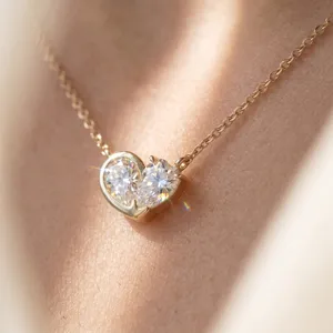 Close-up of elegant S925 silver heart moissanite pendant necklace with sparkling gems.