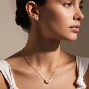 Close-up of a model wearing sparkling heart moissanite necklace and stud earrings set