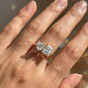 Close-up of lab-grown diamond ring with heart and square cut stones showing rainbow fire