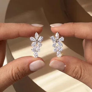 Close-up of geometric 925 silver stud earrings featuring D color VVS lab diamonds
