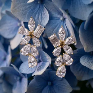 Detailed macro shot of 925 silver lab diamond floral earrings nestled in blue hydrangeas