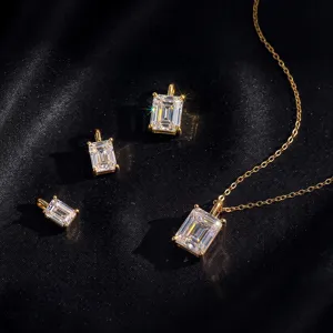 Macro view of emerald-cut lab diamond necklace and pendants on black silk background