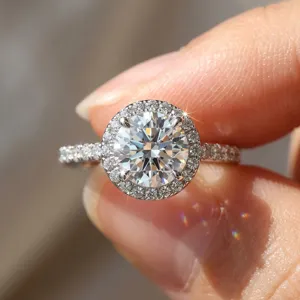 Close-up of sparkling moissanite engagement ring with halo design in sterling silver
