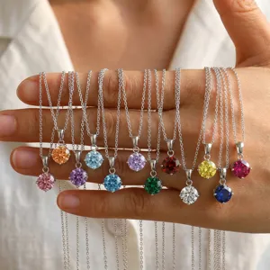 Close-up of multi-color cubic zirconia pendants on silver stainless steel chains for women