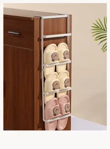 Detail showing white metal over-the-cabinet side shoe rack hanging on a wooden cabinet