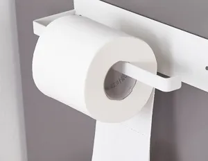 Detailed view of a white magnetic paper towel holder rack mounted on a refrigerator side