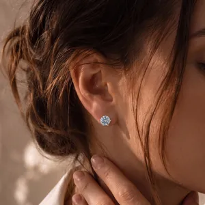 Nahaufnahme eines 14K Goldsteckers mit VVS-Labor-Diamanten am Ohr eines Models
