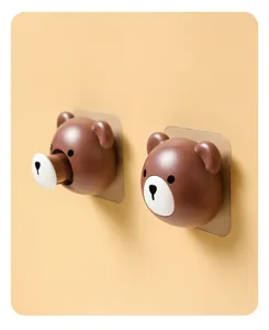 Detail view of a creative brown bear retractable cable organizer and storage hook