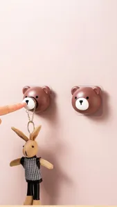 Detail showing the retractable chain mechanism of a bear-shaped wall hook organizer.