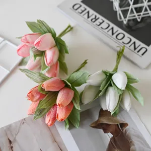 Close-up of artificial tulip bouquets with green leaves for photo styling and DIY decor.