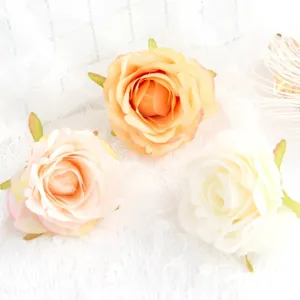 Artificial silk rose flower heads for DIY crafts, wedding garlands, and gift box decoration details.