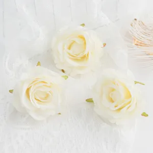 Close-up detail of white artificial rose flower heads for DIY crafts and wedding decor.