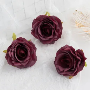 Close-up detail of dark red artificial rose flower heads for DIY crafts and wedding decoration.