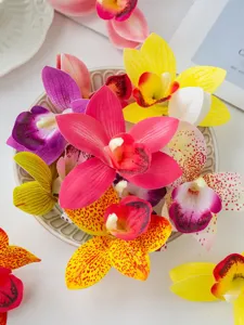 Detail view of artificial film cymbidium flower heads for cake and dessert decor crafts.