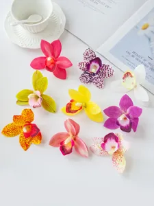 Artificial orchid flower heads close up, colorful Cymbidium details for cake decoration