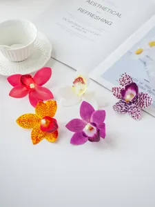 Close-up detail of colorful artificial orchid flowers, perfect for dessert table decoration.