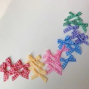 Colorful plaid mini ribbon bows detail shot for DIY crafts, hair accessories and creative projects.