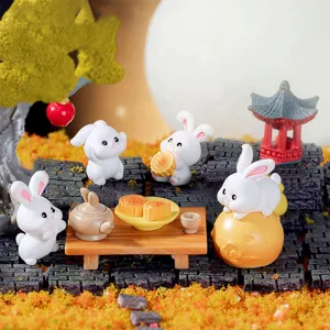 Close-up detail of cute resin rabbit and mooncake miniature ornaments for festival decor.