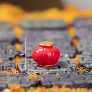 Miniature red lantern resin craft detail shot, micro landscape decoration ornament closeup view.
