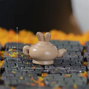 Miniature resin rabbit teapot figurine, cute micro landscape ornament for desktop and decor.