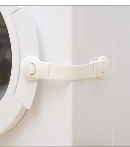 Close-up of white baby safety strap lock installed on a washing machine door.
