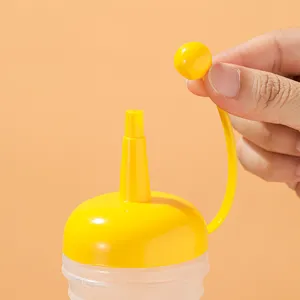 Plastic sauce squeeze bottle with yellow nozzle cap for condiments like ketchup and jam