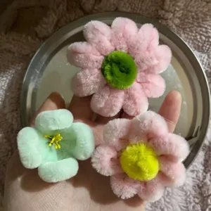 Handmade pipe cleaner flowers detail, fluffy DIY bouquet craft material, soft wool root decor.