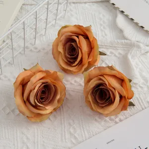 Artificial rose flower heads in gradient orange, perfect for wedding bouquets and home decor.