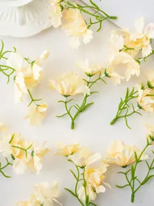 Artificial mini orchid flower heads flat lay detail for DIY crafts and home decor.
