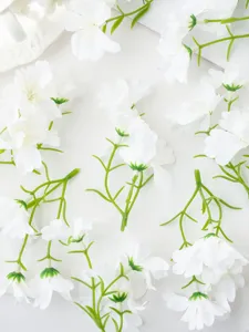 White artificial flower detail close-up, ideal for DIY crafts, floral decor and accessories.