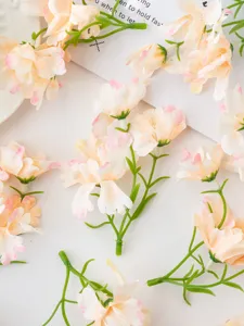 Artificial orchid flower head detail, DIY craft material, home decor accessory close up.