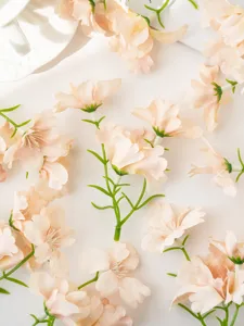 Artificial small orchid flower heads for DIY crafts and home decor detailing view.
