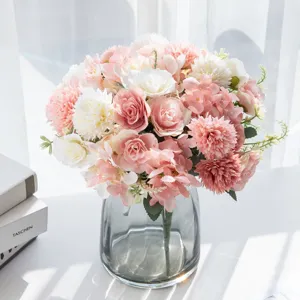 Artificial peony hydrangea flower bouquet in grey glass vase for home decor detail shot.