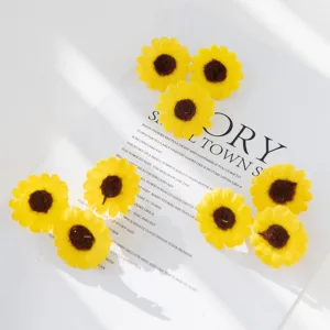 Closeup of artificial yellow sunflower heads, silk flower DIY accessories for crafts.