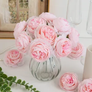 Artificial pink peony silk flowers bouquet in glass vase for home wedding party decor.