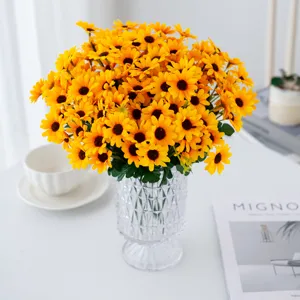 Artificial sunflower bouquet in clear glass vase, fake yellow flowers for home room decor.