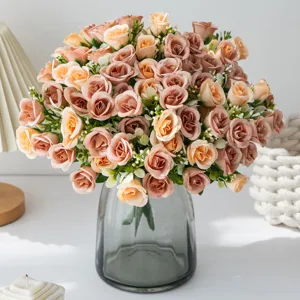 Close-up detail of artificial rose flower bouquet in grey glass vase for home wedding decor.