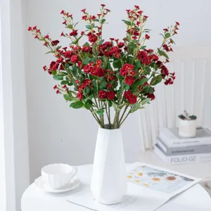 Artificial red rose flower branch for home decor and wedding floral arrangement setup.