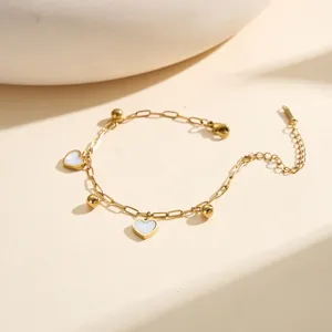 Detailed view of a gold stainless steel bracelet with delicate heart-shaped charms.