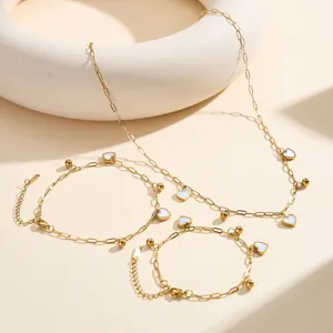 Detailed shot of gold-plated stainless steel jewelry set with white heart charms