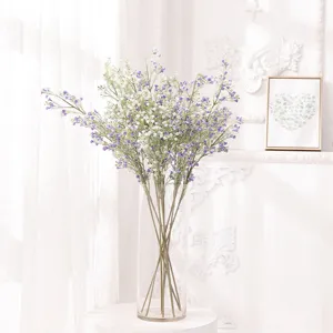 Detailed view of artificial gypsophila bouquet in glass vase for home wedding floral decor.