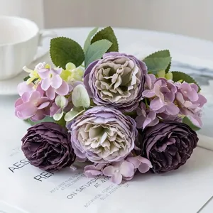 Close-up of artificial purple peony and hydrangea bouquet, wedding floral detail backdrop.
