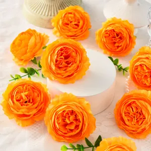 Orange artificial silk peony flower close-up detail, ideal for wedding decor and floral props.
