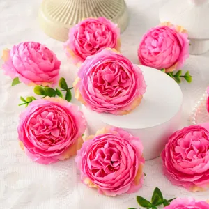 Closeup detail of 8cm artificial silk peony flowers in pink with green leaves for decor.